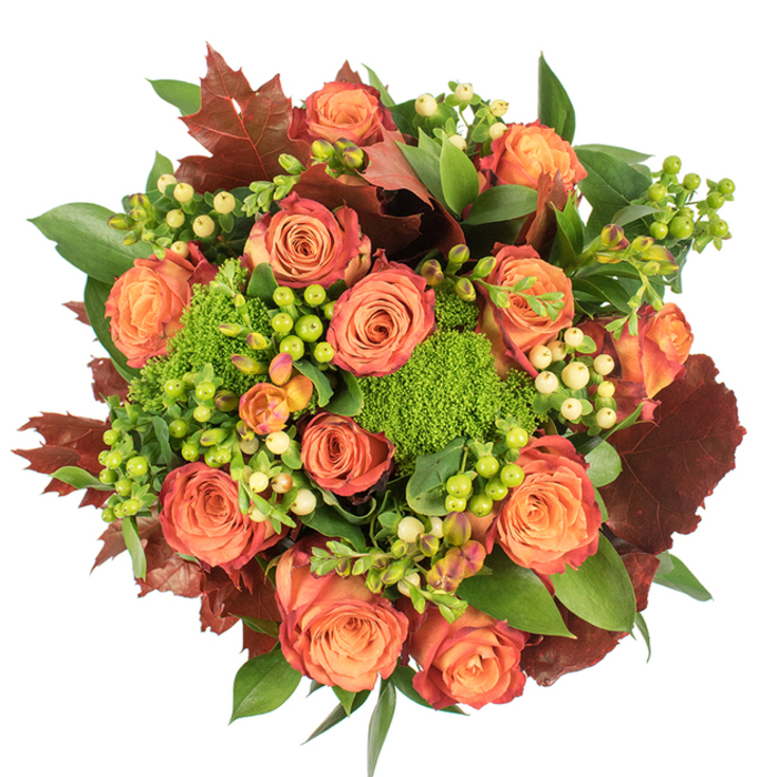 Seen directly from above, this autumnal bouquet presents a dense, circular composition that celebrates texture and warm colour transitions. The focal point is a collection of large, fully bloomed roses whose petals graduate from pale peach at the heart through coral to richer orange and russet at the outer edges - a painterly gradient that echoes the changing leaves of late autumn. Nestled between these classic roses are tight clusters of Hypericum berries: some a bright, almost neon lime-green that injects a celebratory lift, others a delicate creamy-yellow that softens and refines the palette. Punctuating the arrangement are easily spotted mounds of Green Trick dianthus, their compact, velvety, moss-like forms creating a tactile contrast to the roses' soft petals and adding architectural interest. Broad green foliage fills and supports the bouquet, while strategically placed lobed leaves in deep crimson and burnt umber, reminiscent of dried oak or maple, give the design depth and a seasonal anchor. The lighting is even and soft, illuminating petal textures and the glossy surfaces of the berries while producing gentle shadows that enhance the bouquet's layered feeling. The overall mood is warm, abundant and exquisitely tactile - a centrepiece well-suited to a Thanksgiving table, a housewarming in the surrounding West Norwood and Crystal Palace neighbourhoods, or a thoughtful gift to convey gratitude. Texturally rich and fragrant in a subtle, woody way, this arrangement feels handcrafted and composed with the kind of care local customers expect from an experienced neighbourhood florist.
