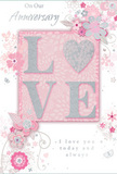 This anniversary card presents a gentle celebration of enduring romance, much like a quiet stroll through a blossom-filled corner of Gipsy Hill on a soft spring evening. At the centre, the word LOVE stands out in softly raised glitter, each letter carefully shaped and edged with a fine shimmer that reflects light with a silvery glow. The letter O is transformed into a delicately textured heart, its surface covered in sparkling silver tones that give it a jewel-like presence against the muted background. Surrounding this focal point, clusters of stylized blooms unfurl in shades of blush, mauve, and pale rose, their petals fading at the edges like watercolour on textured paper. Thin, flowing lines trace out the stems and leaves, curving around the card in graceful, looping paths that suggest both motion and care, reminiscent of the sweeping arcs in a professionally crafted bouquet. Tiny flourishes-small petals, faint swirls, and barely-there butterflies-are scattered across the soft pink backdrop, adding a sense of quiet movement, like leaves gently shifting in the breeze along Gipsy Hill's leafy streets. Silver accents catch the eye at the tips of petals and along the curves of vines, adding dimension without overpowering the pastel calm. The phrases On Our Anniversary and I love you today and always appear in an understated, romantic script, their flowing letters echoing the curves of the floral design. Altogether, the card feels like a tender, keepsake piece meant to accompany an intimate anniversary gift, as thoughtfully composed as fresh flowers delivered to a loved one in the Gipsy Hill area.